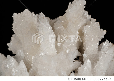 Macro stone Calcite mineral on a black background 111776502