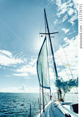 Yachting on sail boat during sunny weather 111776751