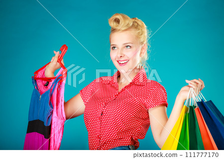 Pinup girl with shopping bags buying clothes dress 111777170
