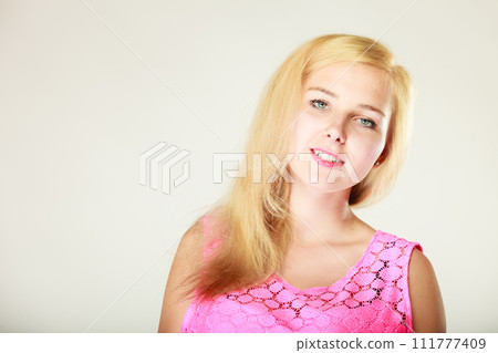 Happy smiling blonde woman in pink top Happy smiling blonde woman in pink top 111777409