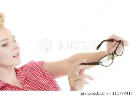 Blonde pin up girl holding retro glasses 111777414