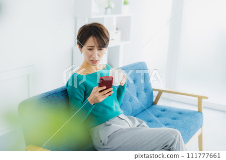 A woman watching a smartphone 111777661