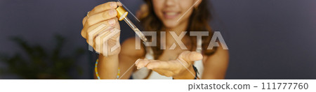Web banner with beauty blogger applying brightening face serum 111777760