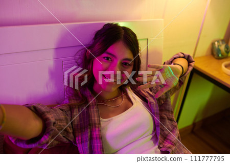 Teenage girl taking selfie or filming video for her blog Teenage girl taking selfie or filming video for her blog 111777795