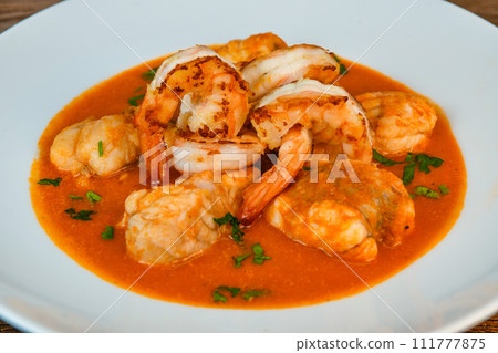 Recipe for Armorican-style monkfish tail, prawns, flambees with cognac 111777875