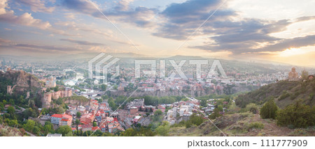 Beautiful panorama of Tbilisi on the background of spectacular blue sky with clouds Beautiful panorama of Tbilisi on the background of spectacular blue sky with clouds 111777909