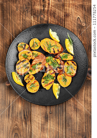 Grilled sweet potato on a plate. Grilled sweet potato on a plate. 111778254