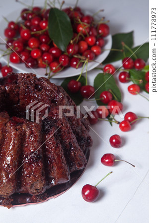 Chocolate cake with sweet cherry on white background.. 111778973