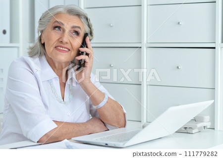 Portrait of senior business woman talking with phone Portrait of senior business woman talking with phone 111779282