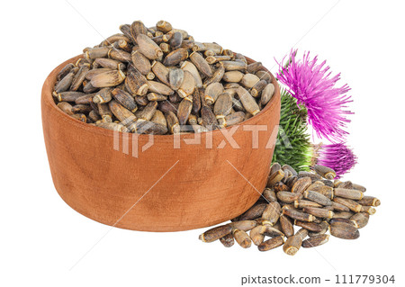 Seeds of a milk thistle or Silybum marianum, Scotch Thistle, Marian thistle in wooden bowl with flower isolated on white background 111779304