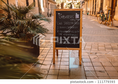 Street menu next to cafe. cCoffee menu in black board outdoors at restaurant 111779393