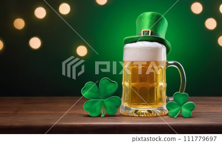 mug of beer with leprechaun hat and shamrocks on the wooden table. St. Patrick's Day celebration 111779697