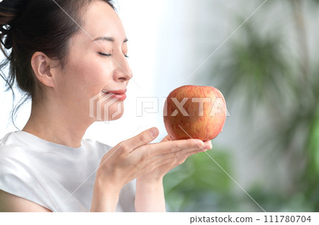 Beauty image of a woman holding an apple in her hand Beauty image of a woman holding an apple in her hand 111780704