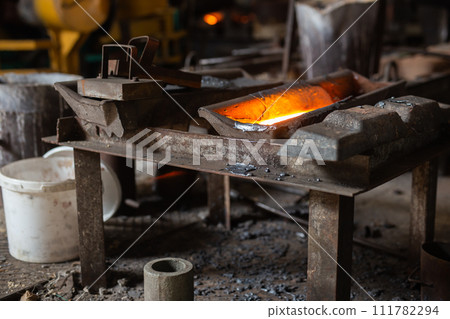 Mold with molten metal in the foundry workshop of metallurgical plant 111782294