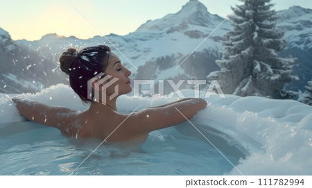 Woman relaxing in hot bath outdoors, sitting back and enjoying beautiful view on snowy mountains. Winter holidays in the mountains, hot water treatments concept 111782994