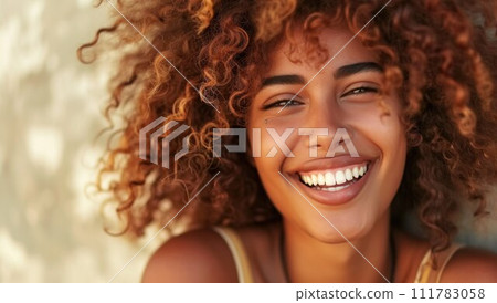 Happy laughing American African woman with her curly hair. Laughing curly woman in sweater touching her hair and looking at the camera Happy laughing American African woman with her curly hair. Laughing curly woman in sweater touching her hair and looking at the camera 111783058