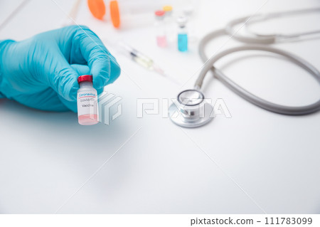 Researcher holding vaccine sample in the laboratory. Researcher is inventing vaccines to treat COVID-19 virus. 111783099