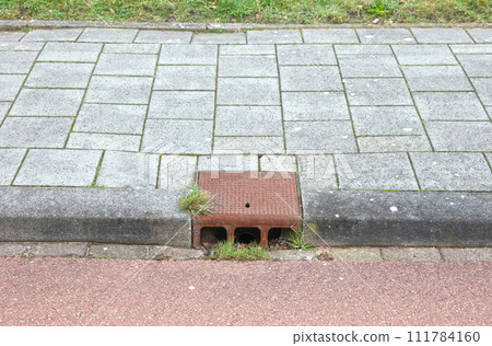 Manhole cover in a dutch street Manhole cover in a dutch street 111784160