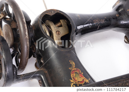 Broken old sewing machine, isolated on white Broken old sewing machine, isolated on white 111784217