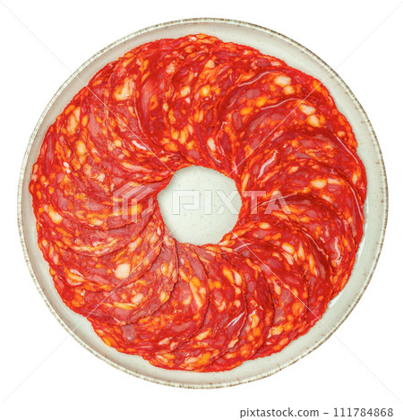 sliced chorizo salami on plate isolated on white background 111784868