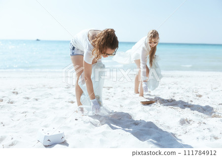environment activists on ocean coast collecting garbage environment activists on ocean coast collecting garbage 111784912