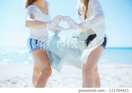 Eco activists collecting trash and showing heart hands 111784921