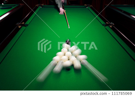 Strong hit by a player with a billiard cue on the ball Strong hit by a player with a billiard cue on the ball 111785069