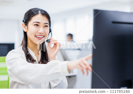 Young woman working in a call center 111785280