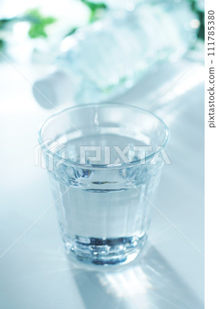 Mineral water in a glass and a plastic bottle 111785380