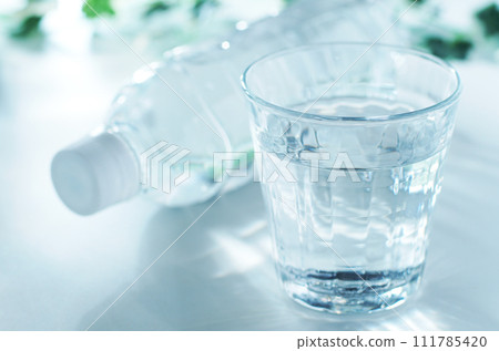 Mineral water in a glass and a plastic bottle Mineral water in a glass and a plastic bottle 111785420