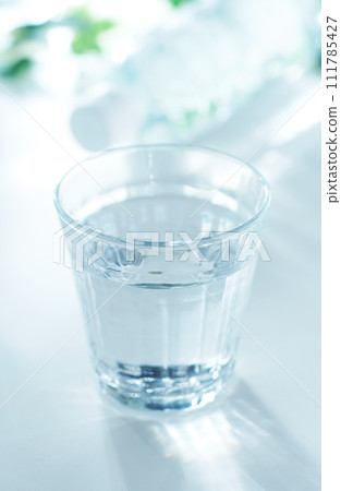 Mineral water in a glass and a plastic bottle Mineral water in a glass and a plastic bottle 111785427