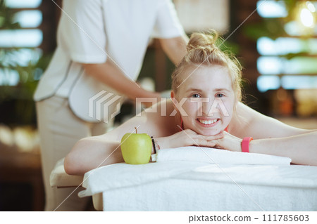 female therapist in massage cabinet making massage 111785603