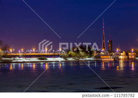 View of the AB dambis of Riga, during the blue hour of a winter night. The TV tower stands out in the skyline View of the AB dambis of Riga, during the blue hour of a winter night. The TV tower stands out in the skyline 111785782