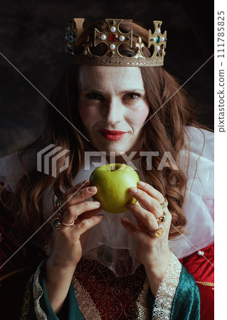 insidious medieval queen in red dress with green apple 111785825