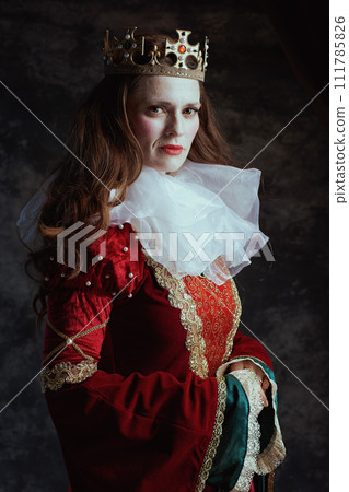 medieval queen in red dress with white collar and crown 111785826