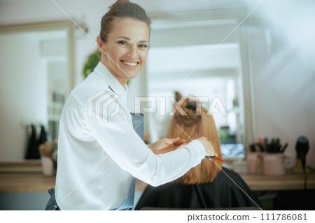 woman hairdresser in modern beauty salon woman hairdresser in modern beauty salon 111786081