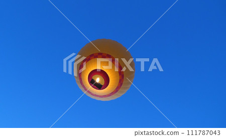 View from below of a balloon flight against the blue sky. Unusual angle. Balloon flight in Cappadocia. Close-up. View from below of a balloon flight against the blue sky. Unusual angle. Balloon flight in Cappadocia. Close-up. 111787043
