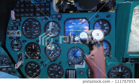 Inside the cabin of the Mi-24 military transport helicopter. Close-up of the control panel, instruments, gauges and steering wheel. A Russian military helicopter. 111787055