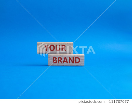 Your Brand symbol. Concept word Your Brand on wooden blocks. Beautiful blue background. Business and Your Brand concept. Copy space 111787077