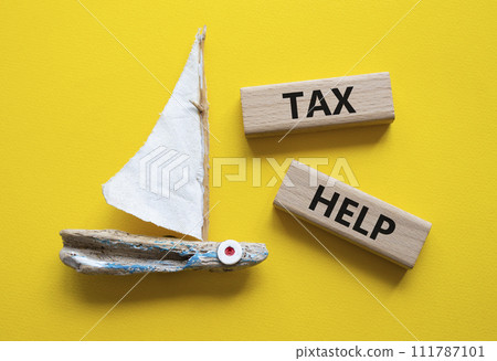 Tax Help symbol. Concept word Tax Help on wooden blocks. Beautiful yellow background with boat. Business and Tax Help concept. Copy space 111787101