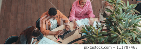 Group of coworkers working together and talking at modern office. Workplace and cooperation concept 111787465