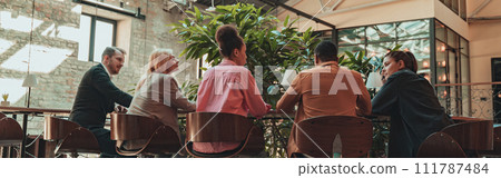 Group of coworkers working together and talking at modern office. Workplace and cooperation concept 111787484