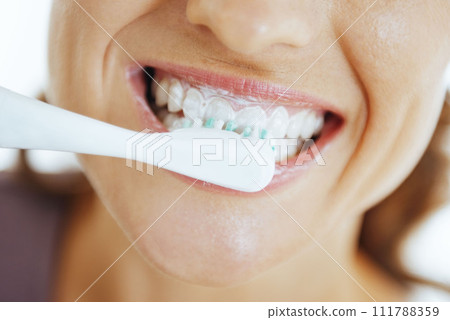 Closeup on happy woman brushing teeth Closeup on happy woman brushing teeth 111788359
