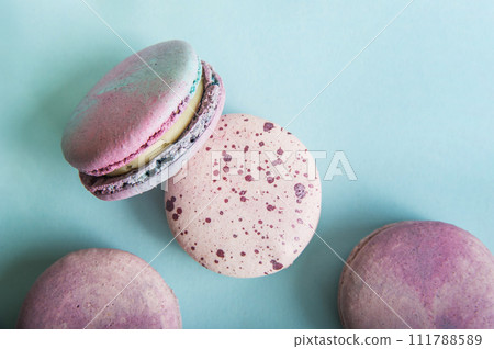 Pink macaroons on blue background close-up and empty space Pink macaroons on blue background close-up and empty space 111788589