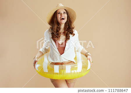 happy stylish woman in blouse and shorts isolated on beige happy stylish woman in blouse and shorts isolated on beige 111788647