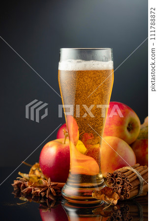 Apple cider in high glass on a black background. Apple cider in high glass on a black background. 111788872
