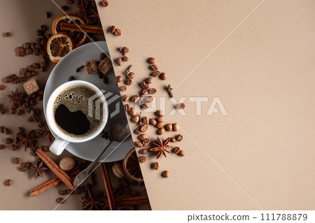 Black coffee  with spices on a beige background. 111788879