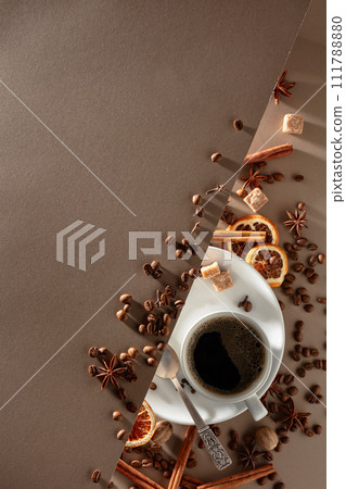 Black coffee  with spices on a beige background. 111788880