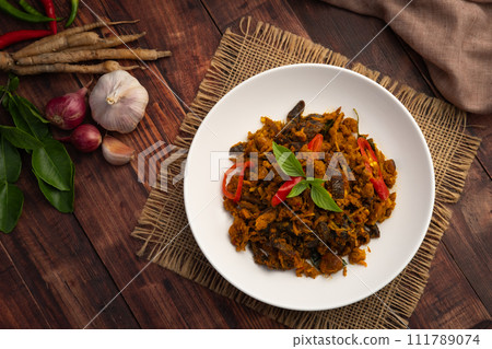 Stir fried spicy grilled sting ray with Thai red curry paste in white plate.Top view Stir fried spicy grilled sting ray with Thai red curry paste in white plate.Top view 111789074