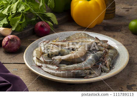 Close up Fresh raw shrimp (Litopenaeus vannamei) on grey plate Close up Fresh raw shrimp (Litopenaeus vannamei) on grey plate 111789113